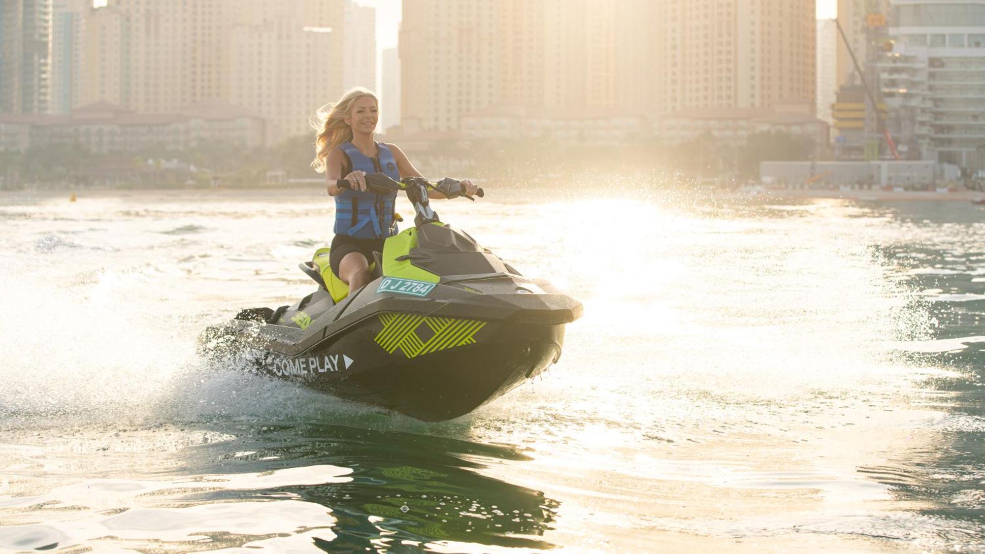 Five Luxe Hotel Dubai Exterior photo A woman riding a personal watercraft