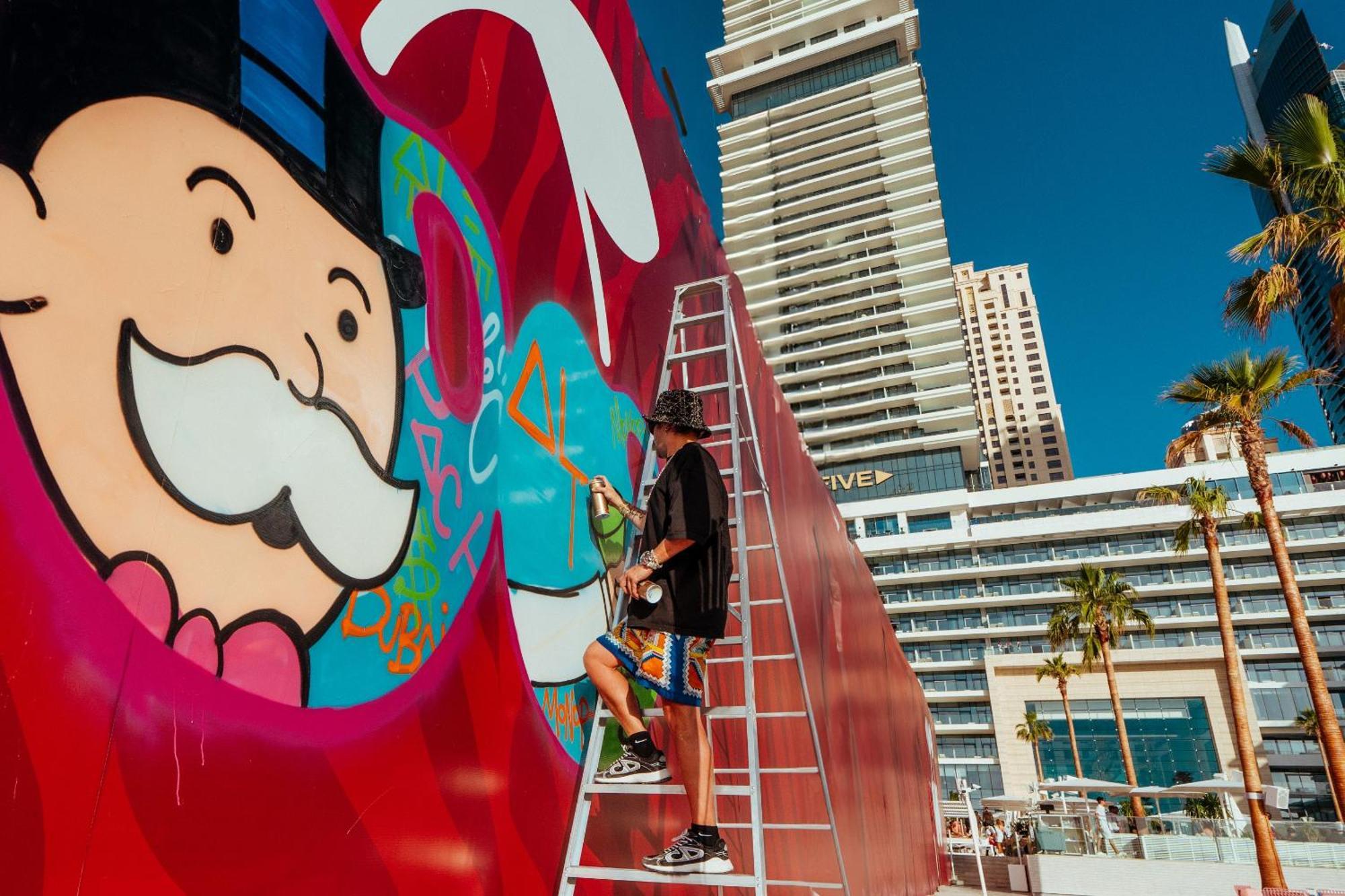 Five Luxe Hotel Dubai Exterior photo Artist working on a mural at the MGM Grand