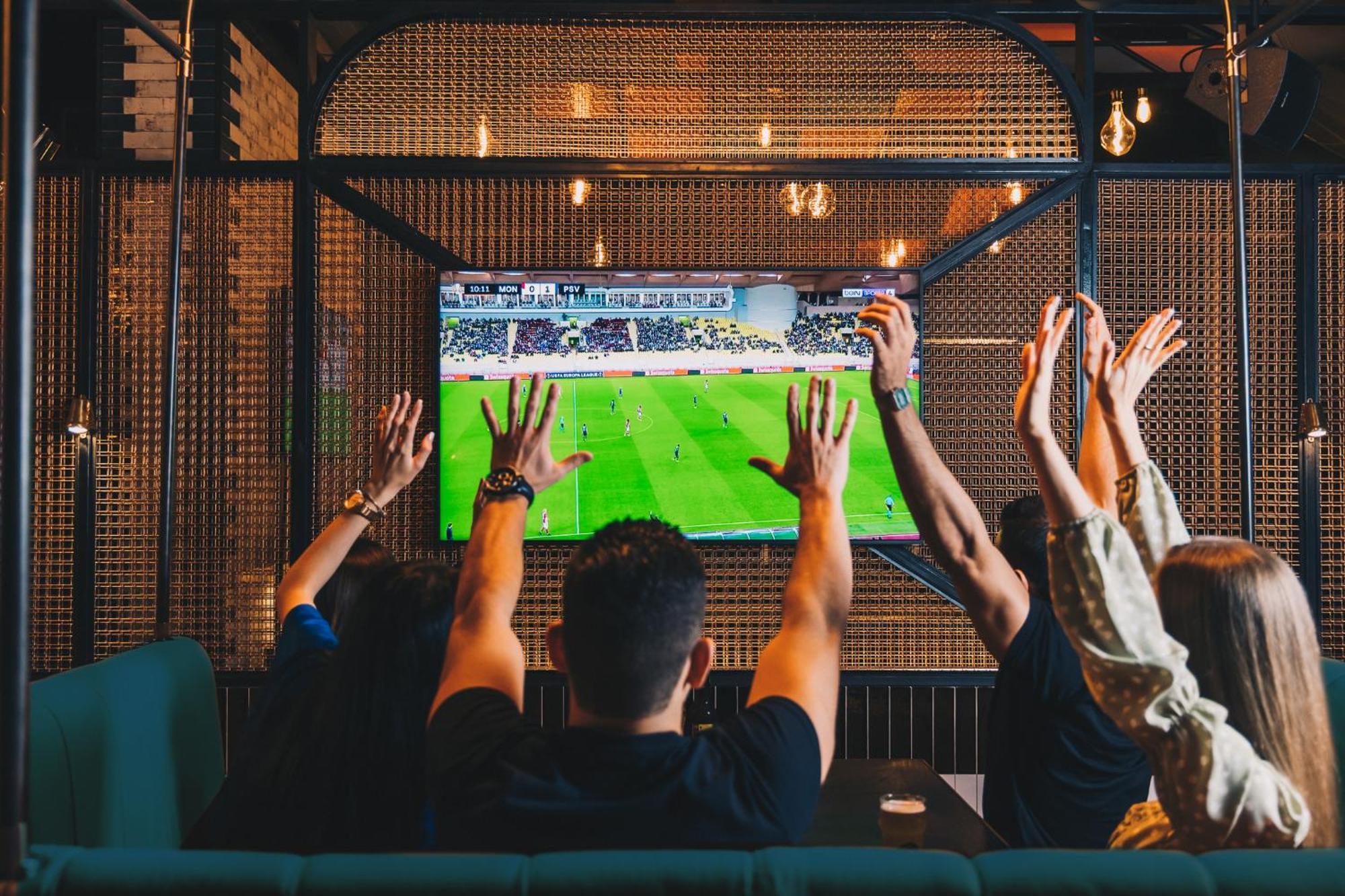 Five Luxe Hotel Dubai Exterior photo Watching a game on television